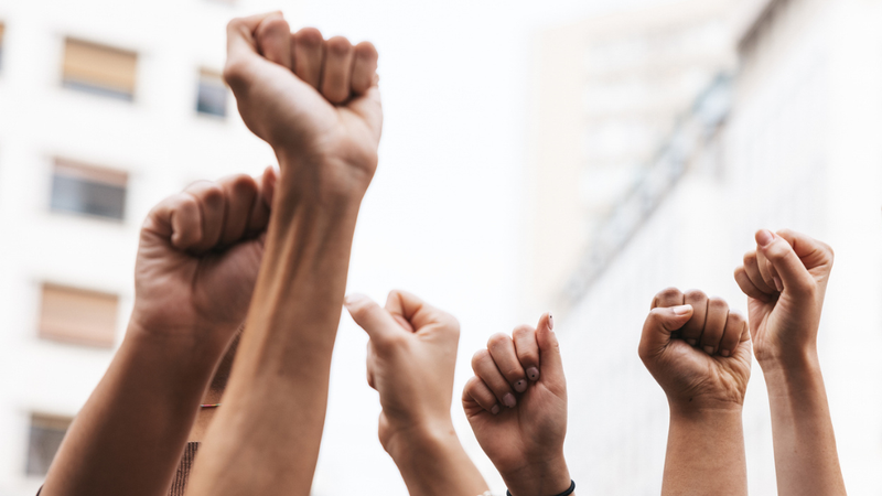 Image of a group of fists being held up in protest