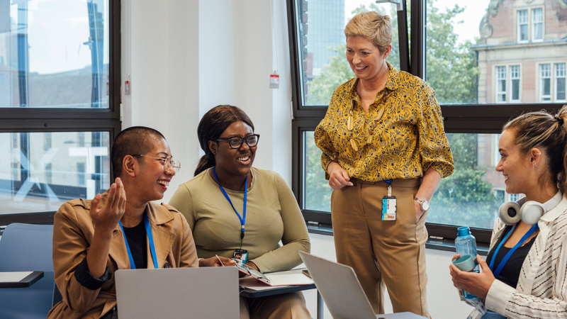 Image of four women having a meeting and laughing