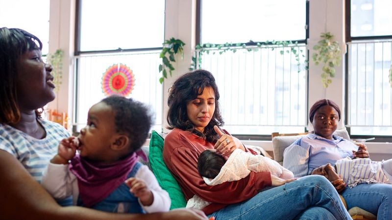 Group of women sitting with their toddlers in a circle