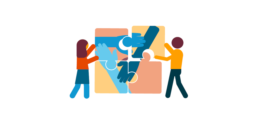 Two people holding together a jigsaw