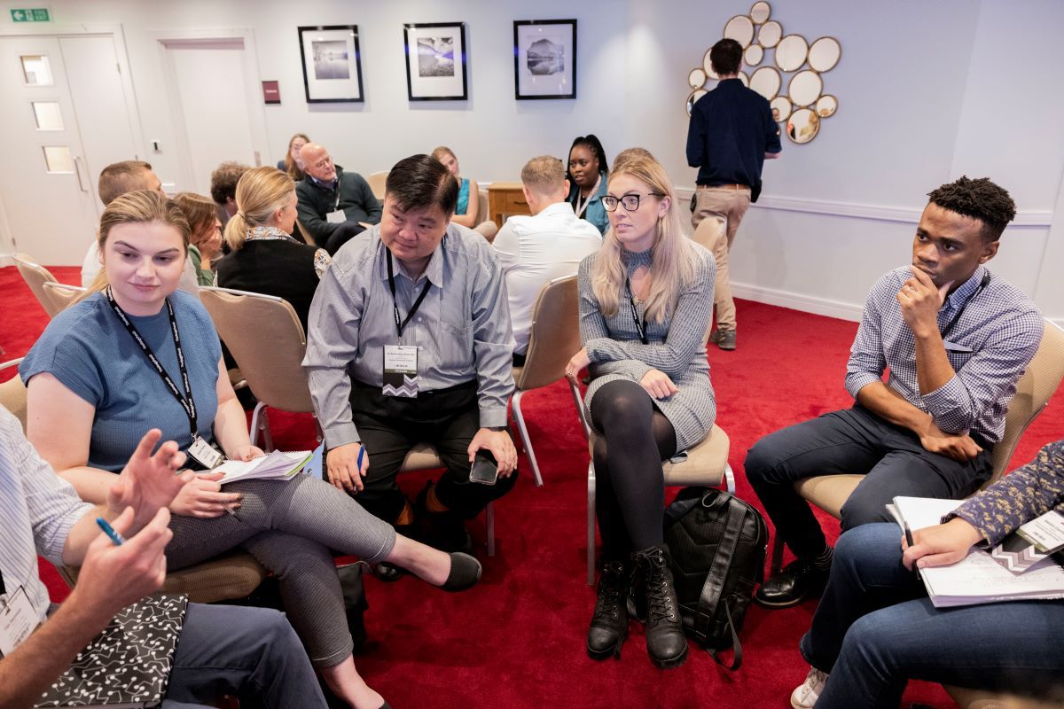 Group of people sat in a circle chatting