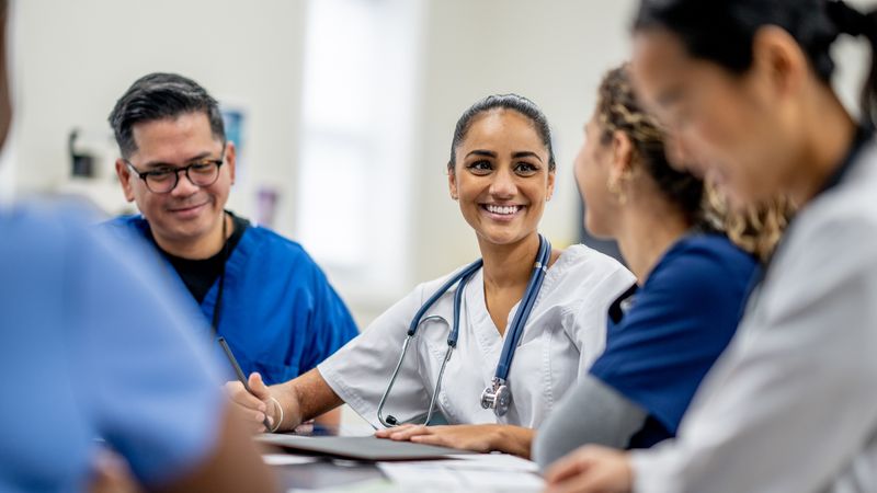 Meeting of clinicians, chatting and laughing