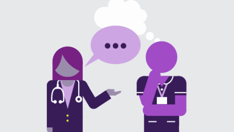 Two health care workers chatting and thinking