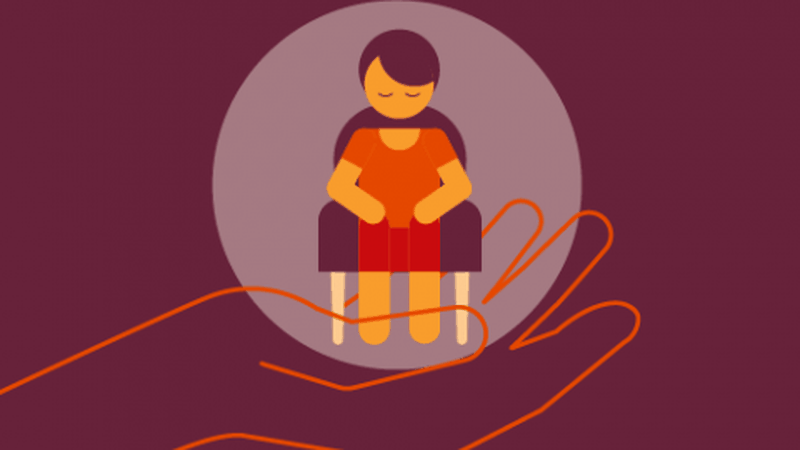 A hand holding a person sitting in a chair