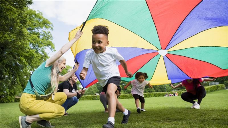 Boy running through a kite