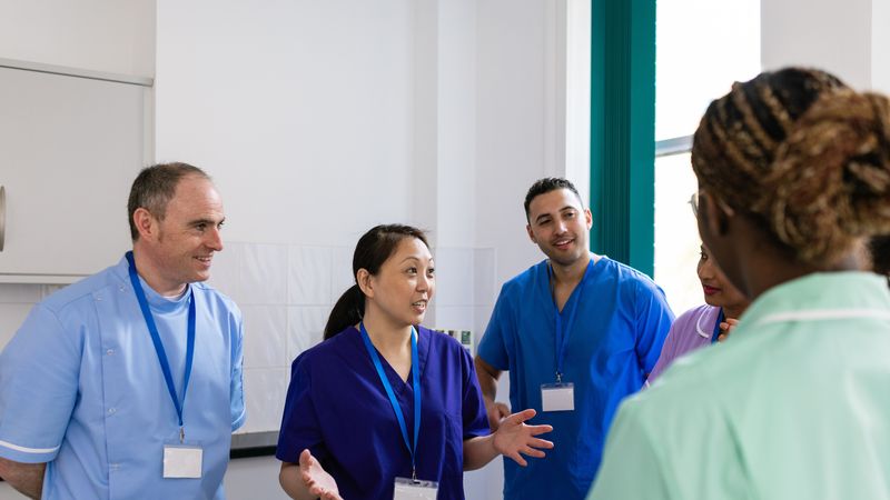 A group of healthcare professionals having a stand-up meeting